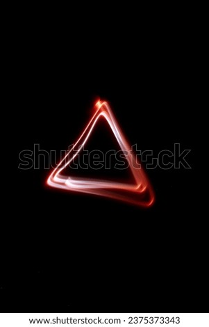 Abstract red lights in the shape of a triangle, white tones, dark background, shapes in the air, luminous lines in darkness, no people, long exposure photography, moving fine lines