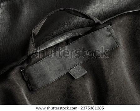 Blank black leather material clothing tag without logo close-up