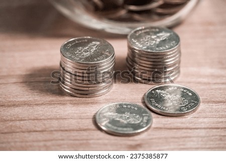 Thai Baht coin on wooden table, Thai money Royalty-Free Stock Photo #2375385877
