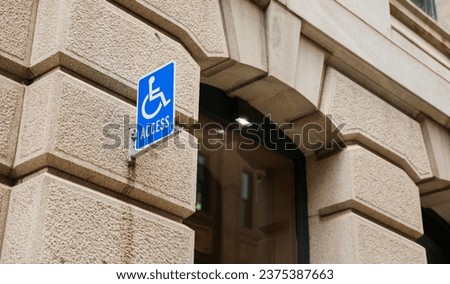 wheelchair accessibility sign against a modern cityscape, conveying equality and mobility for all