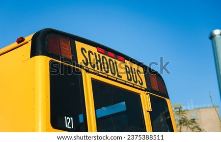 school bus sign on a sunny morning, symbolizing safety, education, and childhood, against a blue sky backdrop