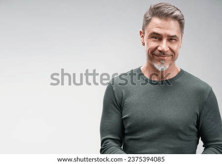 Portrait of happy casual older man smiling, Mid adult, mature age guy standing, isolated on gray background.