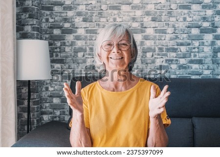 Head shot aged woman qualified psychologist looks at cam during psychological support session on-line counselling with client over telecommunication app. Chat via teleconference with relatives concept Royalty-Free Stock Photo #2375397099