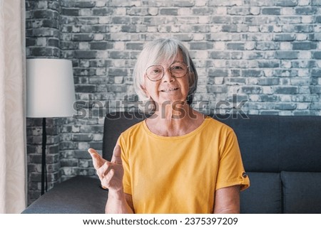 Head shot aged woman qualified psychologist looks at cam during psychological support session on-line counselling with client over telecommunication app. Chat via teleconference with relatives concept Royalty-Free Stock Photo #2375397209