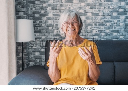 Head shot aged woman qualified psychologist looks at cam during psychological support session on-line counselling with client over telecommunication app. Chat via teleconference with relatives concept Royalty-Free Stock Photo #2375397241