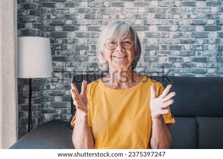 Head shot aged woman qualified psychologist looks at cam during psychological support session on-line counselling with client over telecommunication app. Chat via teleconference with relatives concept Royalty-Free Stock Photo #2375397247