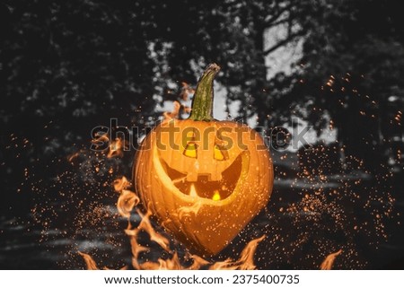 Jack-O'-Lanterns with burning eyes on fire. Halloween Evil Pumpkin face with flickering lights inside on a black and white background