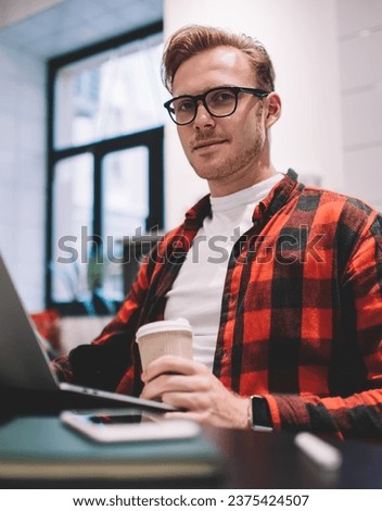 Confident freelancer working on laptop at workspace