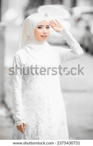 Simple white and clean outfit of Malay girl in Hijab.