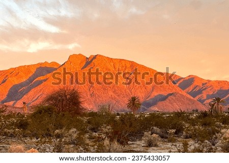 Sunrise illuminating Santa Rosa Mountains in Southern California. View from Borrego Springs in December. Vibrant golden hues. Perfect for nature, travel and scenic visuals. Royalty-Free Stock Photo #2375433057
