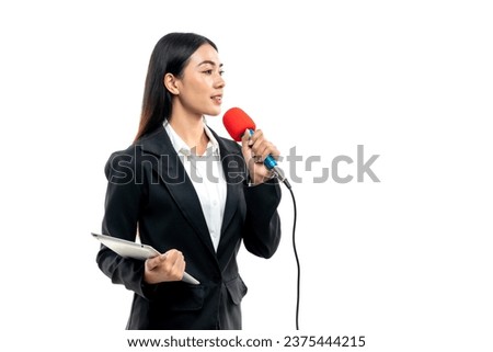 Beautiful Asian female reporter holding tablet while speaking into microphone isolated on white background