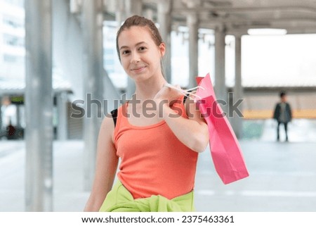Shopaholic Women holding shopping bags ,money ,credit card person at shopping malls.Fashionable Woman love online website with sales tag on black Friday. E-commerce fashion digital marketing lifestyle