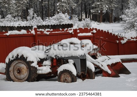 Cool winter picture of old vintage tractors covered in snow.