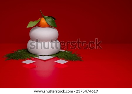 Kagamimochi is an offering to God.
Kagamimochi is on the left side of the red background.
There is no base. Ceramic Kagamimochi. Royalty-Free Stock Photo #2375474619