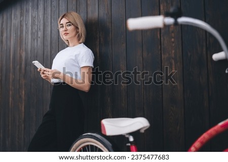 Pretty woman using phone on street