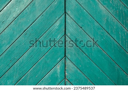 Barn door made of green painted wood. Rustic background. Royalty-Free Stock Photo #2375489537