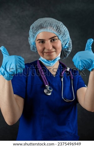 Young female doctor wear uniform shows thumb up in approval, healthcare workers. Overcoming disease illness