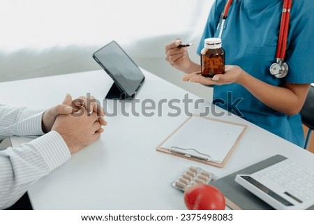 Doctors are giving advice on treatment to patients in hospital examination rooms, treating diseases from specialists and providing targeted treatment. Concepts of medical treatment and specialists. Royalty-Free Stock Photo #2375498083