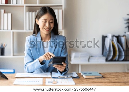 Asian accountants meeting doing accounts payable, assets, capital book value, inventory, liabilities, cost of goods sold. vertical picture Royalty-Free Stock Photo #2375506447