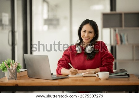 Asian businesswoman working on documents at office