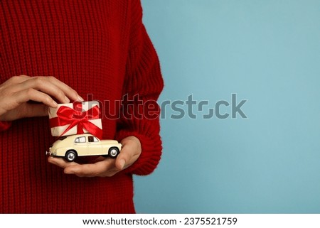 Car with New Year's gifts in hands.