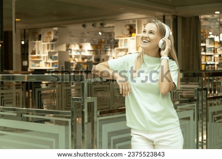 A young woman listens to music in headphones