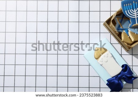 Boxes with gingerbread cookies on light background, space for text