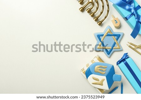 Gingerbread cookies, gift boxes and Hanukkiah on white background, space for text