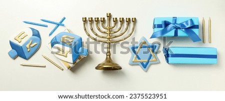Gingerbread cookies, gift boxes and hanukkiah on white background, top view