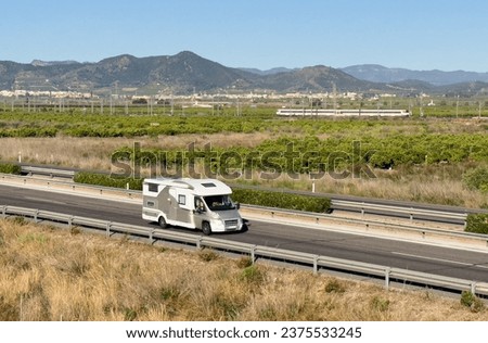 Campervan drive on highway. Family camper van driving on motorway. Motorhome lifestyle travel to sea and mountains. Travel along Spain coast. Traffic cars on road. Royalty-Free Stock Photo #2375533245