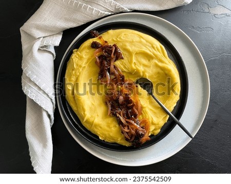 Vegan plate with Greek fava puree served with caramelized onions and dry tomato topping, mystic light food photography