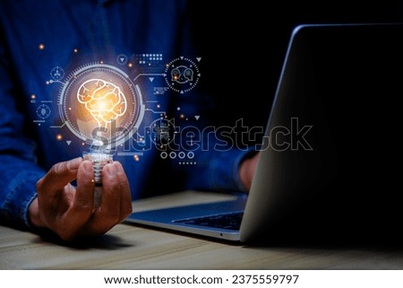 Light bulb in hand businessman. Idea Success with Innovation, Artificial Intelligence technology. AI technology Machine learning data analysis and management, Futuristic technology transformation. Royalty-Free Stock Photo #2375559797