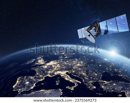 Telecommunication satellite providing global internet network and high speed data communication above Europe. Satellite in space, low Earth orbit. Worldwide communication technology. Royalty-Free Stock Photo #2375569273