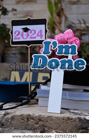 NEW graduation photo  medical field  doctor to be  stethoscope  graduation hat iam done  happy new year , pink flower graduation cap  phot session, M.B.CH.B   medical books class of 2024 ,background