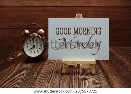 Good Morning Monday text on paper card on wooden background