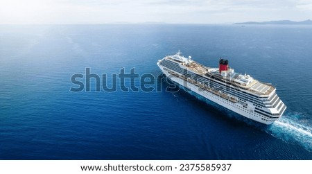 Concept for vacation and travel with a generic cruise ship sailing over the calm ocean with copy space Royalty-Free Stock Photo #2375585937