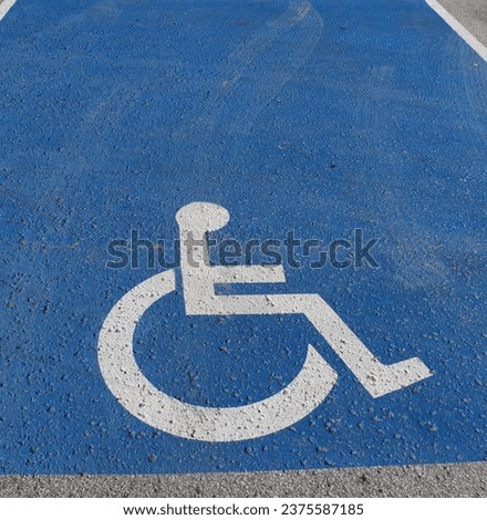 Disabled parking sign on the street. Wheelchair logo.
