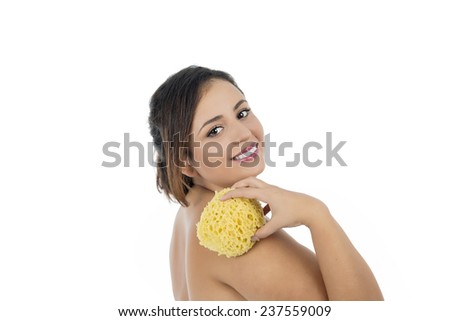 Beautiful young woman holding a bath sponge against a white background