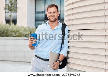 Caucasian man walking around the city during a break in the office.