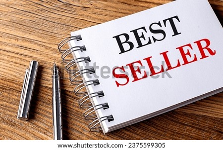 BEST SELLER text on a notebook with pen on wooden background