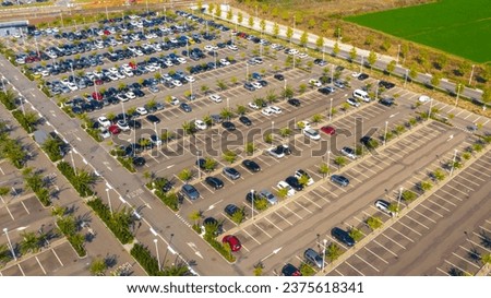 Aerial view of the Reggio Emilia AV Mediopadana station car park. There are many cars parked but also some empty spaces. Royalty-Free Stock Photo #2375618341