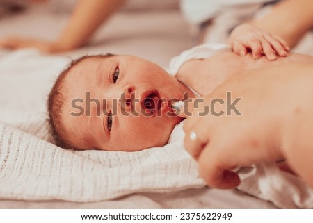 The examination of newborn baby mouth, frenulum of the tongue Royalty-Free Stock Photo #2375622949