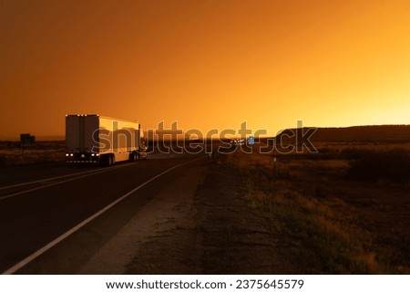 trucks and traffic at sunset. highway road  Royalty-Free Stock Photo #2375645579