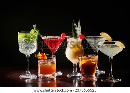 set of different sophisticated cocktails with fresh garnishing on black backdrop, concept Royalty-Free Stock Photo #2375655525