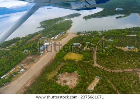 Aerial view of Port Alsworth, Alaska within Lake Clark National Park and Preserve. Private Port Alsworth Airport, public Wilder Natwick Airport, Hardenburg Bay. View from seaplane.  Royalty-Free Stock Photo #2375661071