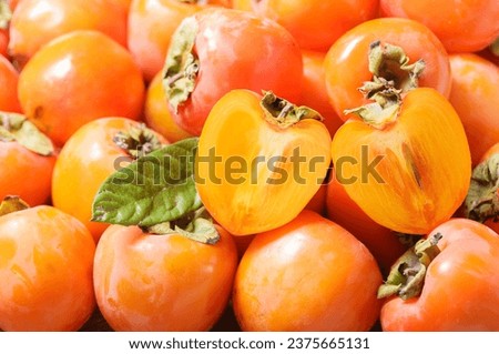 fresh ripe persimmon fruit as background Royalty-Free Stock Photo #2375665131