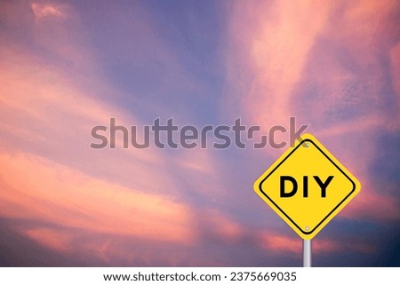 Yellow transportation sign with word DIY (abbreviation of do it yourself) on violet color sky background