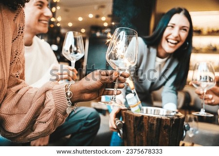 Young people drinking champagne wine in fancy bar - Happy friends hanging out on weekend enjoying luxury prive service at night club - Beverage life style concept