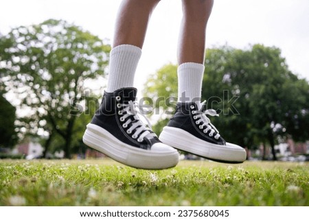 Stylish black sneakers on the grass