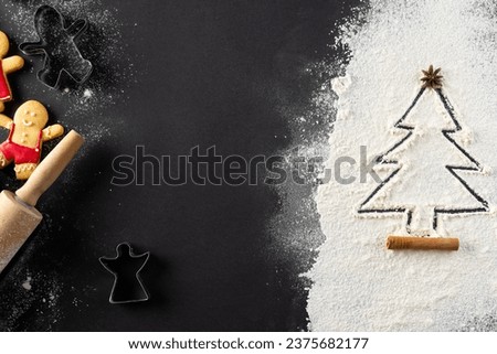 Vertical image of christmas cookies, anis seed and christmas tree shape in flour with copy space. Sweets, christmas, tradition and celebration concept.